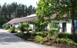 a white house with a street sign in front of it at NATURAMA Brombachsee Trollwald in Pleinfeld