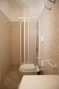 a bathroom with a shower with a toilet and a sink at Verande Tanca Torre in Isola Rossa +132 photos