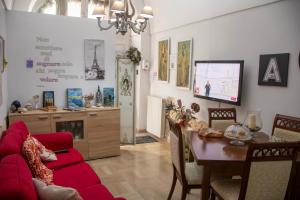 a living room with a red couch and a table at Almasol in Cassano delle Murge