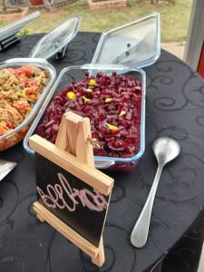 a table topped with trays of food and a spoon at Emmanuel Guesthouse in eMalahleni +30 photos