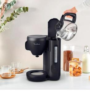 a black coffee maker on a counter with a person holding a light at Serene Villa in Grand-Baie