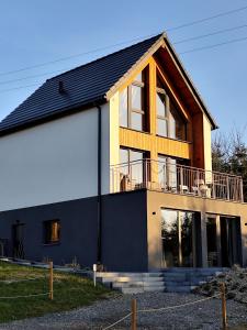 a large house with a large white garage at Wśród Gór in Istebna