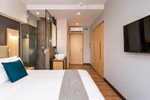a hotel room with a bed and a bathroom at St. Bjur Suites in Athens
