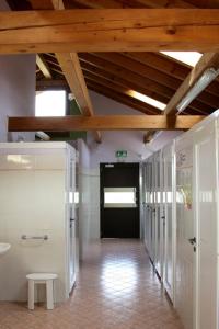 a hallway in a building with a black door and wooden ceilings at Lodge Holidays - Camping Gajole in Arsiè