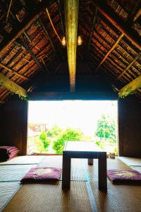a bench in a room with a large window at 淵明庵 in Fujikawa +56 photos