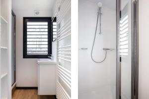 a bathroom with white walls and a shower at de Valreep - Paviljoenwei 4 Offinga in Offingawier