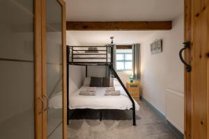 a bunk bed in a room with a mirror at Bryn Lon Bach in Caeʼr-geiliog