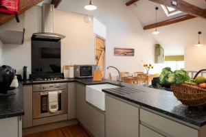 a kitchen with a counter top with a stove top oven at Bryn Lon Bach in Caeʼr-geiliog