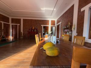 a dining room with a table with fruit on it at vuyen villa in Phú Quốc