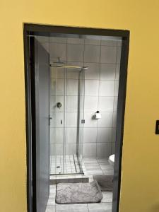 a bathroom with a shower and a toilet in a room at The Arrose Guest House in Kwamhlanga +13 photos