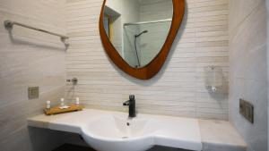 a bathroom with a sink and a mirror at Hotel Dakhla Club & SPA in Dakhla