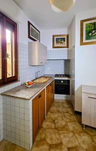 a kitchen with a sink and a stove at il trullo di giada e mattia in Alberobello +69 photos