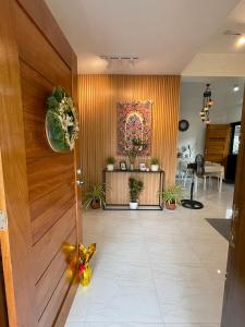a hallway with a wooden door and a table at Qagayon Homestay in Sampong