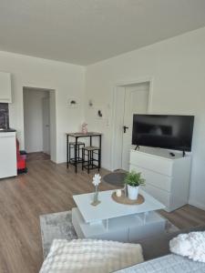 a living room with a flat screen tv and a couch at Hotel Kropper Busch Garni in Kropp