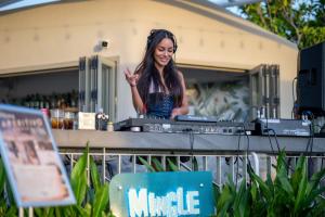 a woman standing behind a table with a mixer at HOMA Cherngtalay Phuket in Bang Tao Beach