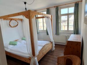 a bedroom with a wooden bed with a canopy at Gasthof Sonne in Schiltach