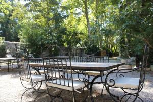a group of tables and chairs in a park at Domaine Notre Dame des Anges in Lurs