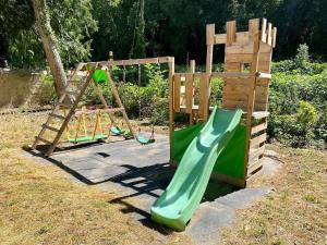 a playground with a green slide and a ladder at Domaine Notre Dame des Anges in Lurs +4 photos