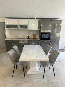 a kitchen with a table and chairs in a kitchen at LaTerrazzaA1 in Hamm