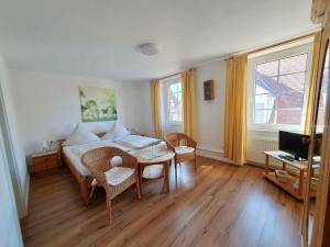 a bedroom with a bed and a table and chairs at Gasthof Sonne in Schiltach