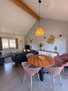 a living room with a wooden table and chairs at Bois de l'Ourthe 202 in Somme-Leuze +37 photos