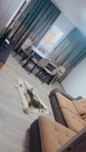 a living room with a couch and a table and chairs at Mountain Retreat in Vulcan
