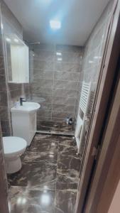 a bathroom with a toilet and a sink at Mountain Retreat in Vulcan