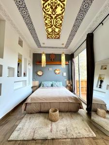 a bedroom with a king sized bed with a coffered ceiling at Zeri Surf Taghazout Hiltop in Taghazout
