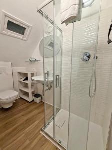a bathroom with a shower with a toilet and a sink at Central Apartment Monterosso in Monterosso al Mare +9 photos