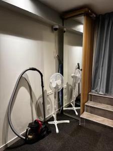 a room with a blow dryer in front of a mirror at Welcome in Issy-les-Moulineaux