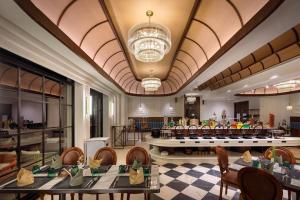 a restaurant with tables and chairs and a lobby at Bhangeri Durbar Resort in Nagarkot