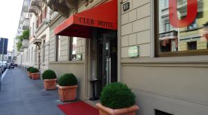 a building with a sign for a club hotel at Club Hotel in Milan