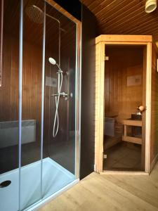 a shower with a glass door in a room at Gite Ard'zen in Noiseux +49 photos