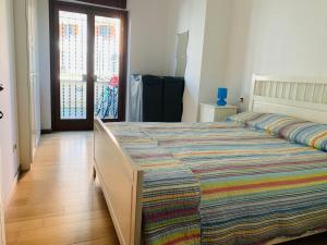 a bedroom with a large bed with a colorful comforter at Pescasseroli center Case del Parco in Pescasseroli