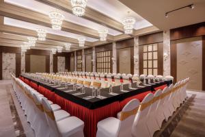 a large conference room with a long table and white chairs at Bhangeri Durbar Resort in Nagarkot +49 photos