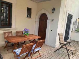 a wooden table and chairs on a patio at Pescasseroli center Case del Parco in Pescasseroli +4 photos