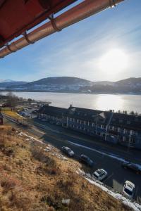 a view of a street with cars parked next to a body of water at Voss Folkehøgskule in Vossevangen