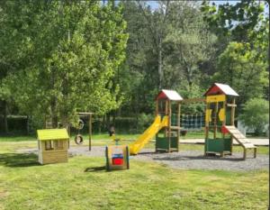a park with a playground with a slide at camping de l'or bleu in Barrême