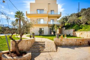 a house with a palm tree in front of it at Chrisselen Stalos in Chania