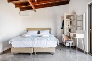 a bedroom with a bed and a desk at Chrisselen Stalos in Chania +54 photos