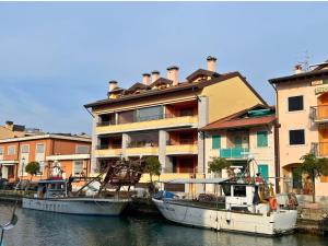 two boats docked in the water next to a building at Stella Marina in Grado