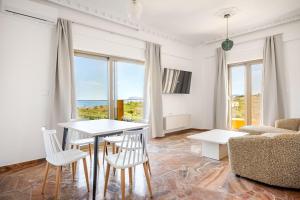 a living room with a table and chairs and a couch at Chrisselen Stalos in Chania