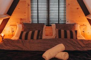 a bedroom with a bed with pillows and a window at Het Punthuisje in Lanaken