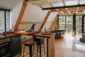 a kitchen with a wooden counter and a bath tub at Het Punthuisje in Lanaken +13 photos