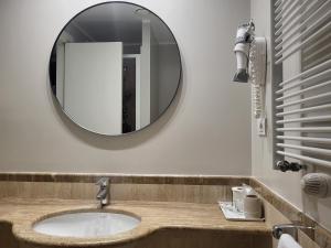 a bathroom with a sink and a mirror at Club Hotel in Milan