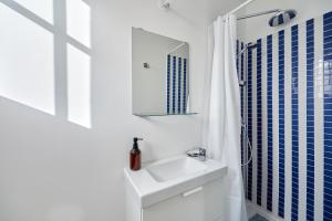 a white bathroom with a sink and a mirror at Les Volets Bleus de Trouville - Centre - Plage in Trouville-sur-Mer +13 photos