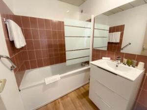 a bathroom with a sink and a shower and a tub at Studio - Plage de Calais - Skatebeach in Calais