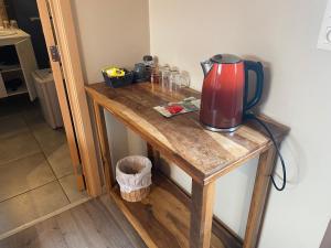 a wooden table with a tea kettle on it at Forges de Pernelle in Couvin