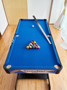 a blue pool table with balls on it at Garden-View ゆふ in Yufu