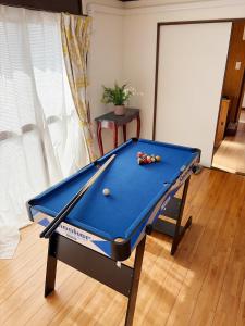 a pool table with balls on it in a room at Garden-View ゆふ in Yufu
